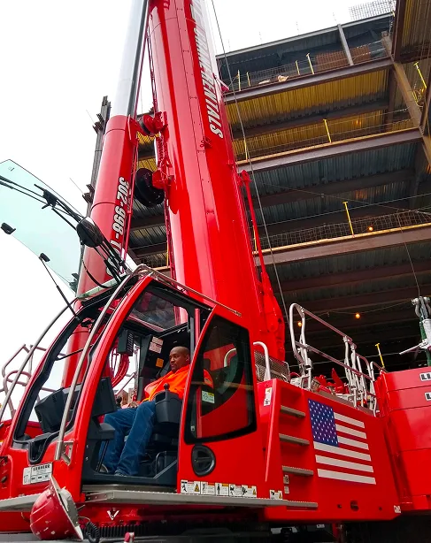Operator in the cab of a red crane