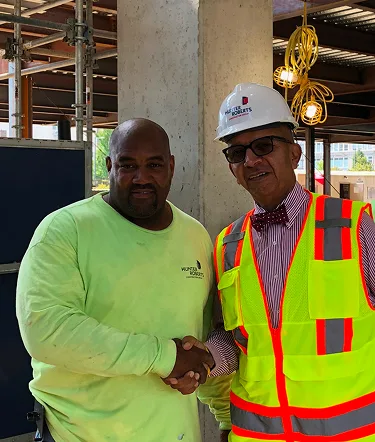 Jimmy Harris shaking hands with a site supervisor