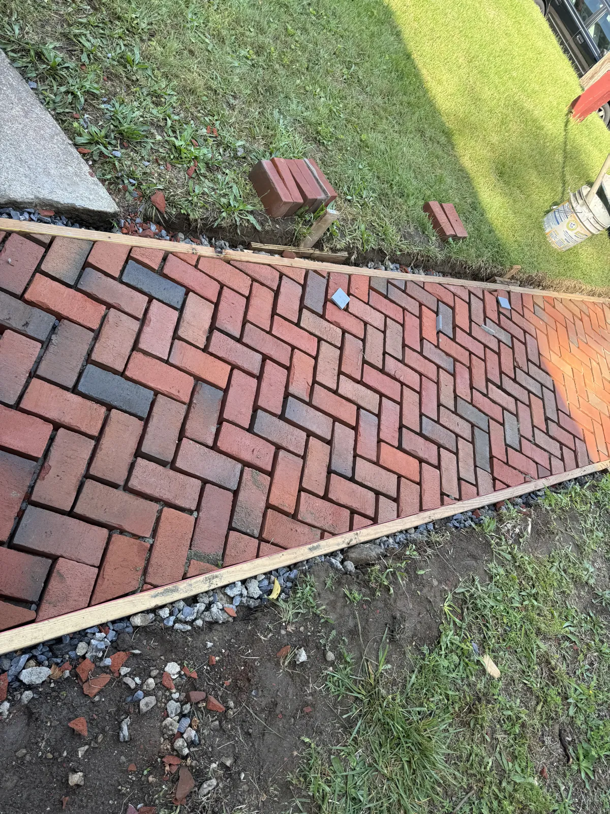 Herringbone brick walkway set in a timber border