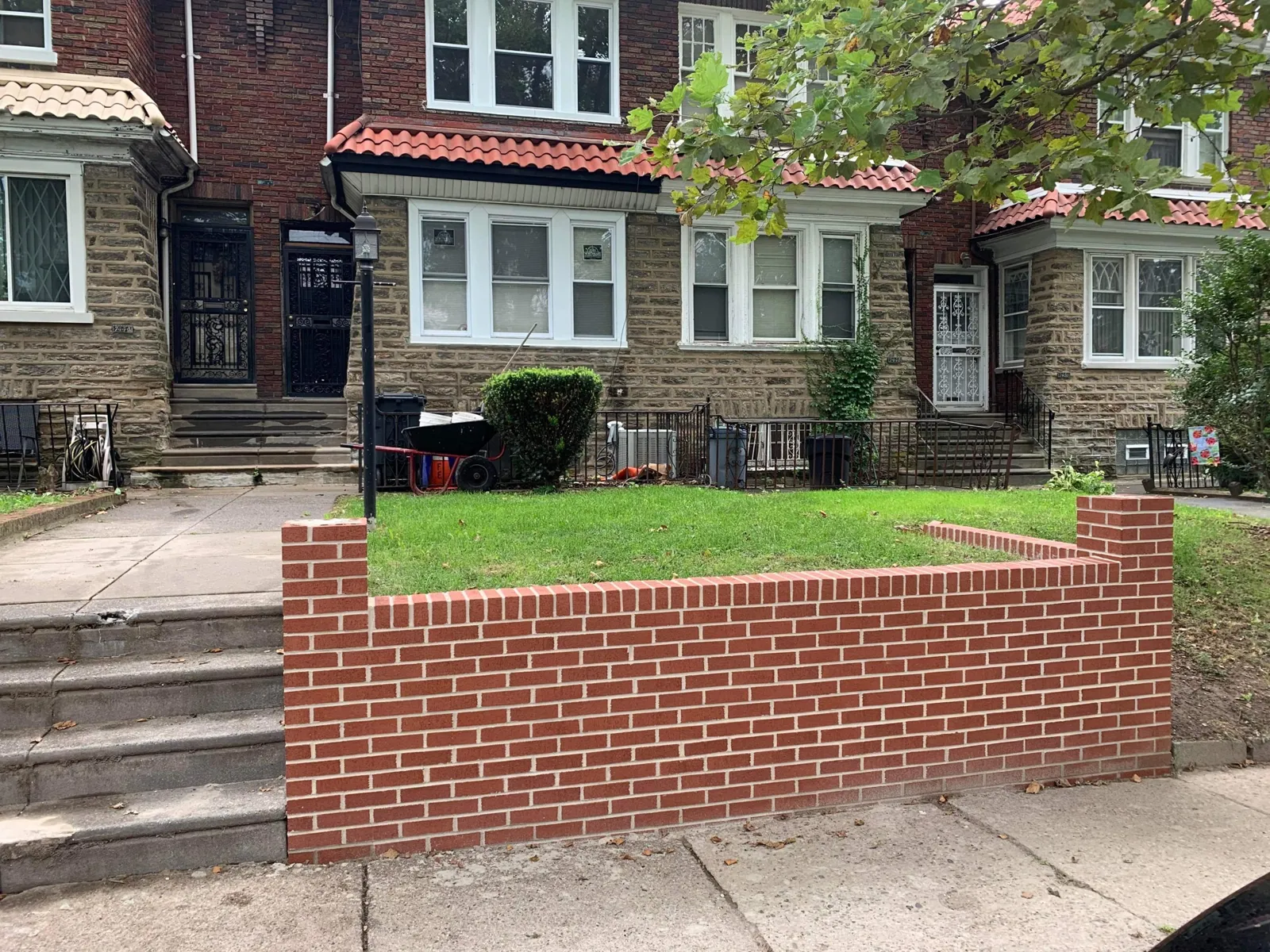 After: finished red brick retaining wall with end piers